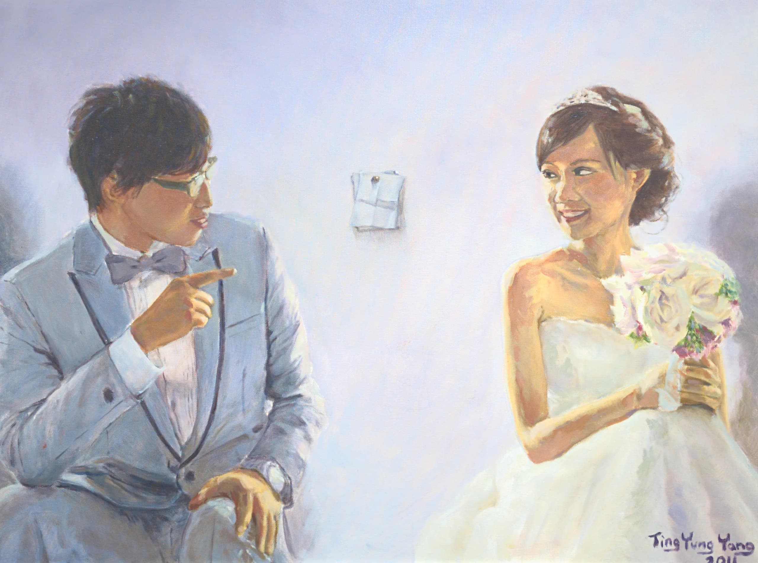 A bride and groom seated, turning toward each other